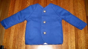 Front view of cobalt blue coat with raglan sleeves and golden buttons
